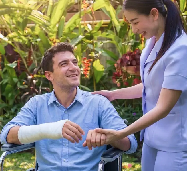 Home health caregiver assisting a patient during an in-home visit