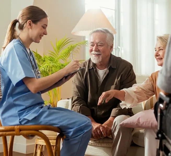 Nurse meeting with an older couple at home for senior care
